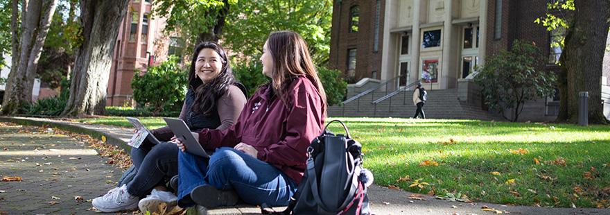 SPU students work together on laptops in Tiffany Loop